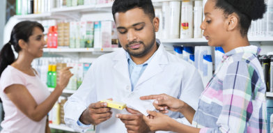 male pharmacist assisting a customer